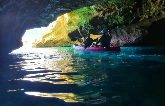 Pareja navegando en kayak dentro de la cueva del lobo marino en Maro Nerja